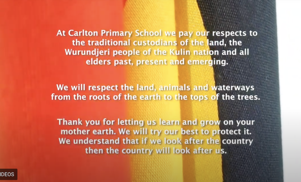An Aboriginal Flag with the words of an Acknowledgement of Country imposed over it.